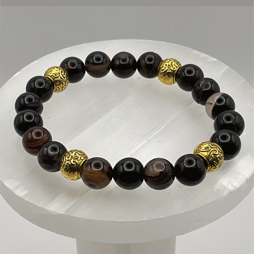 Pulsera de ágata negra con separadores en tono dorado