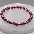 Pulsera de cristal morado con separadores dorados y plateados