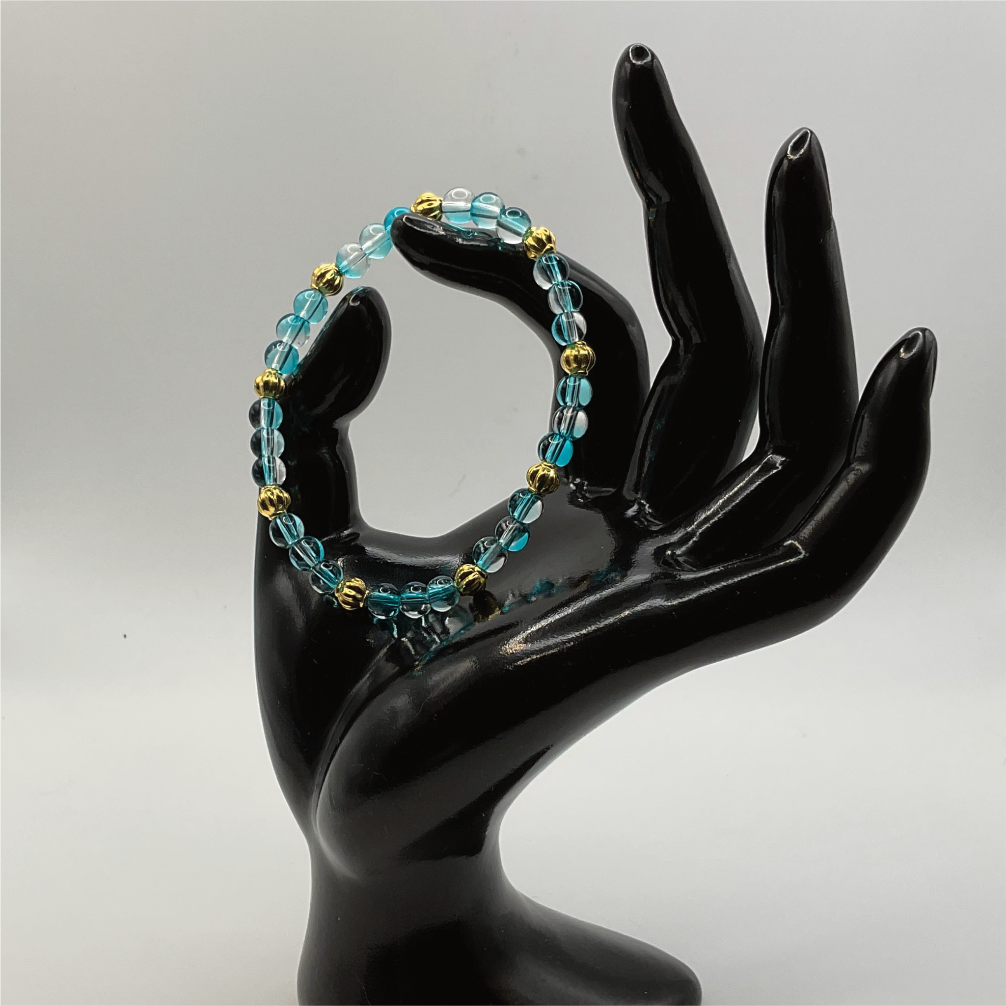 Clear Blue Glass Bracelet with Gold Lobed Spacers