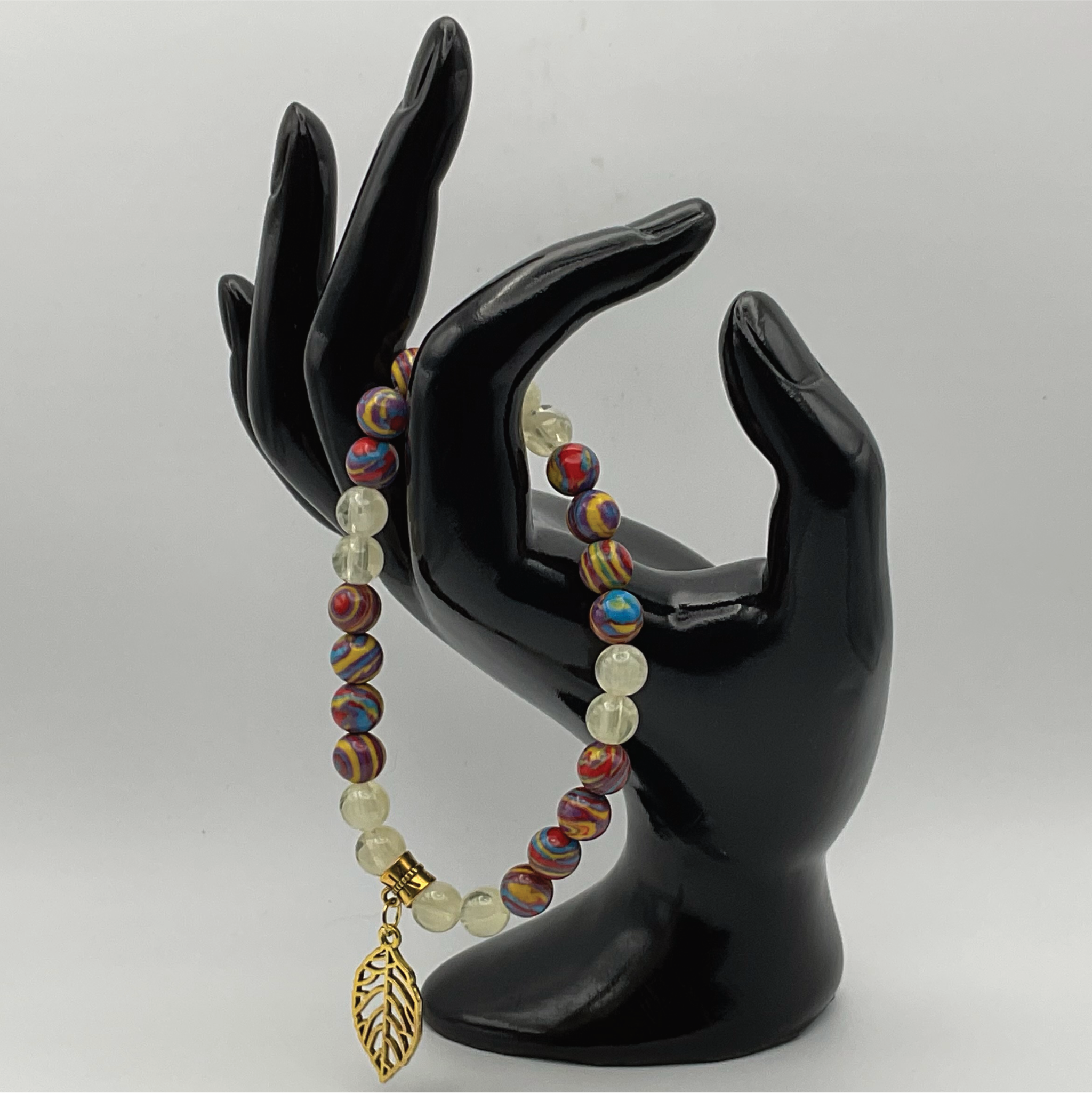 Pulsera con dijes de prehnita y calsilica arcoíris con hoja en tono dorado