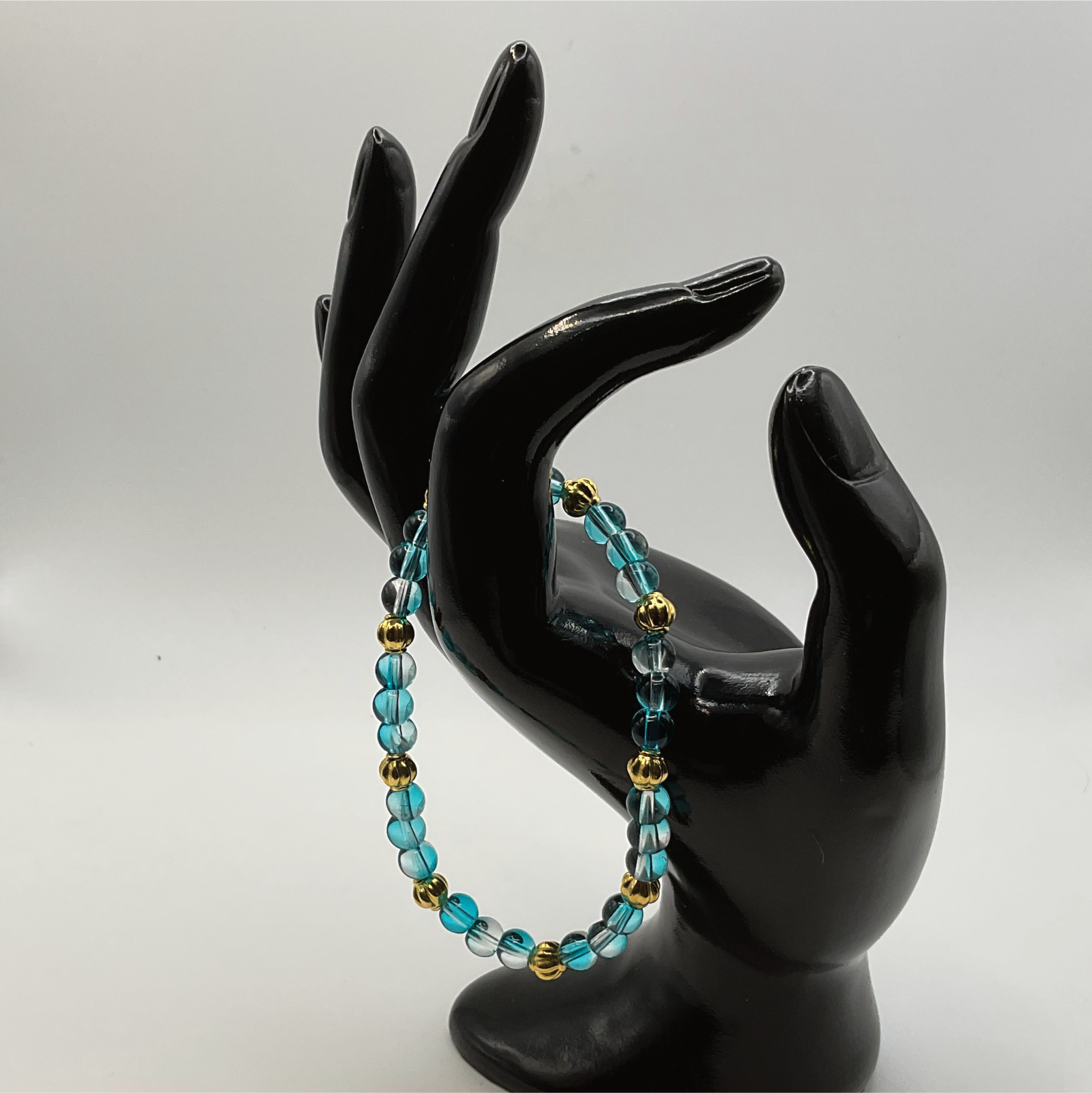 Clear Blue Glass Bracelet with Gold Lobed Spacers