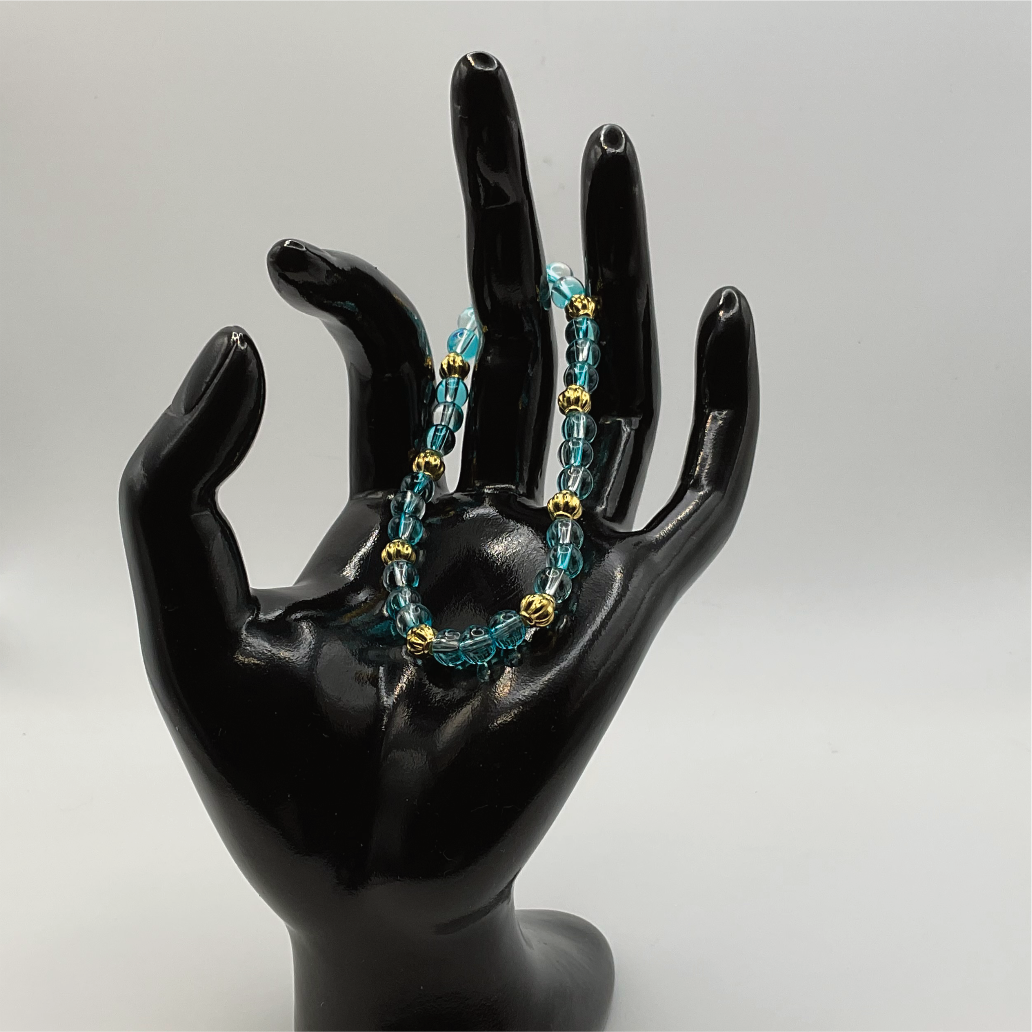 Clear Blue Glass Bracelet with Gold Lobed Spacers